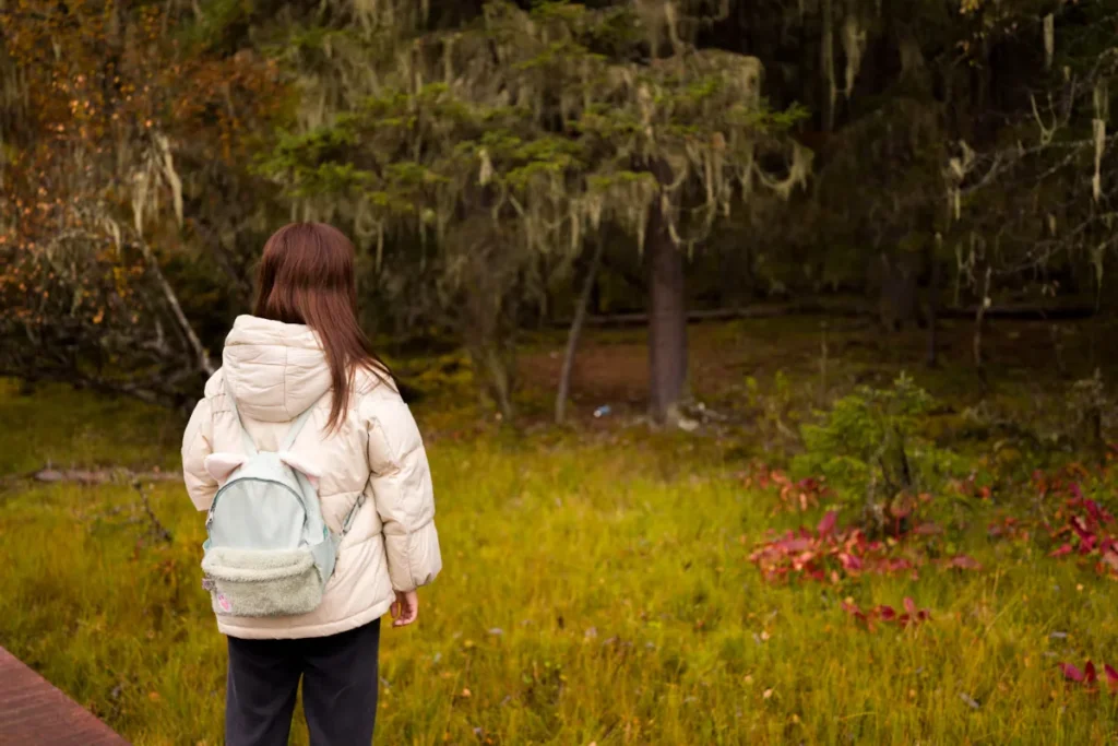 Child Carrying Small Daypack on Forest Walk