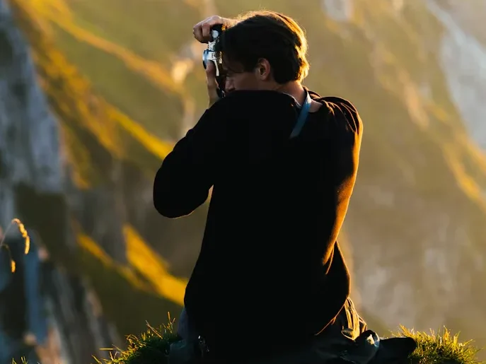 Traveler Taking Photos at Mountain Viewpoint